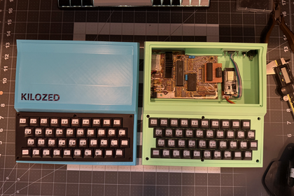 Blue and green KILOZED cases open side by side showing interior components and KILOZED label